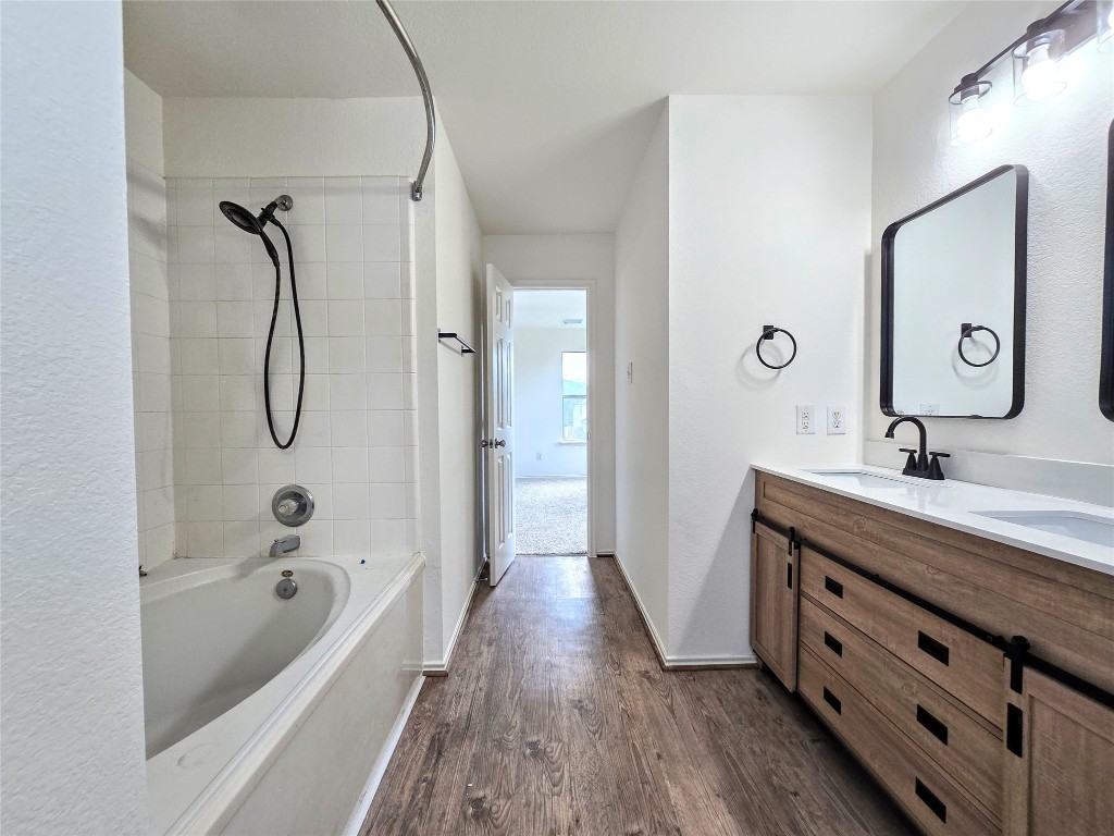 22911 Twisting Maple Court Spring, TX 77373 - Photo 19 of 37 a bathroom with a tub sink and mirror