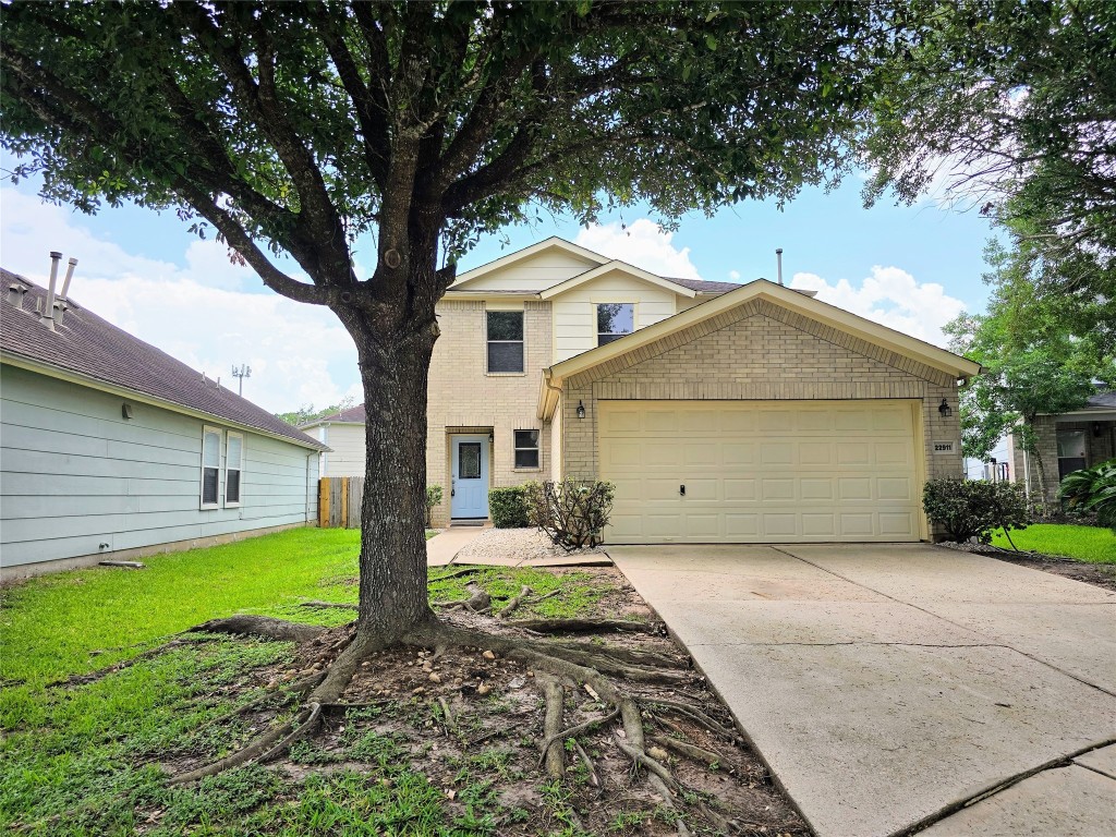 22911 Twisting Maple Court Spring, TX 77373 - Photo 2 of 37 a front view of a house with a yard and garage