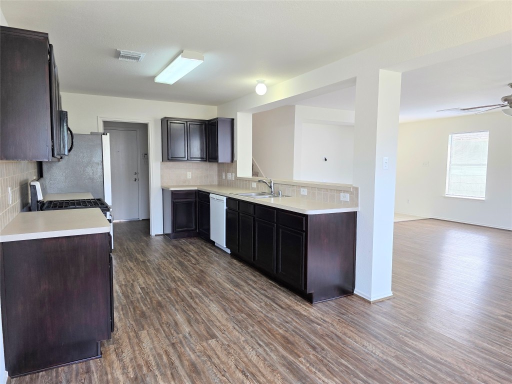 22911 Twisting Maple Court Spring, TX 77373 - Photo 21 of 37 a kitchen with stainless steel appliances granite countertop a sink a stove and a refrigerator