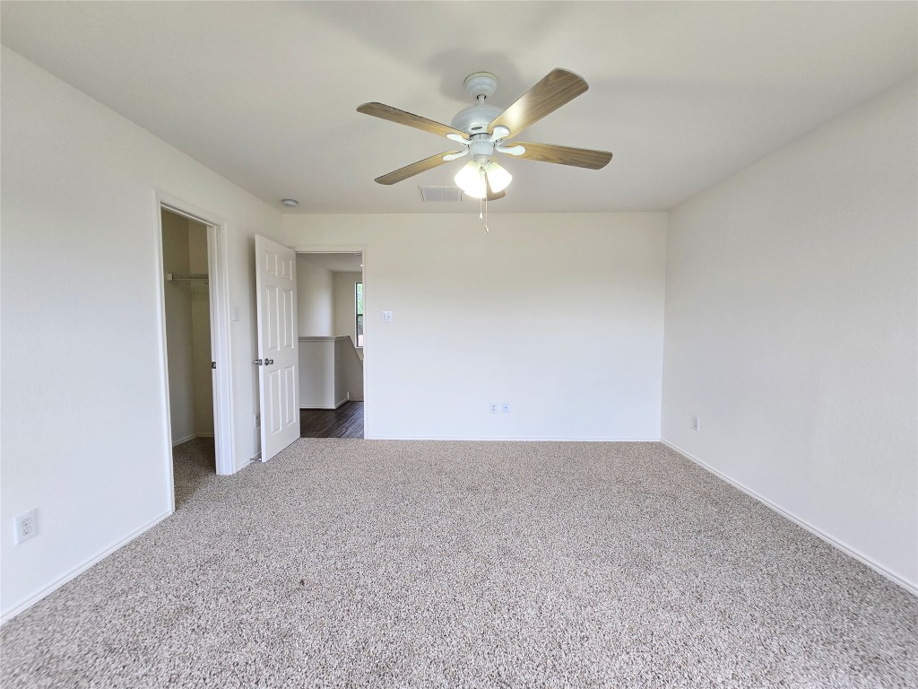22911 Twisting Maple Court Spring, TX 77373 - Photo 26 of 37 a view of an empty room with a chandelier fan