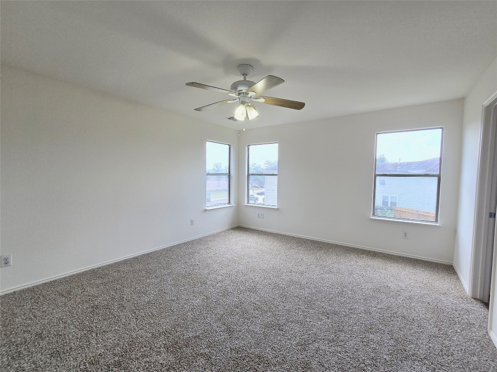 22911 Twisting Maple Court Spring, TX 77373 - Photo 27 of 37 an empty room with windows and ceiling fan
