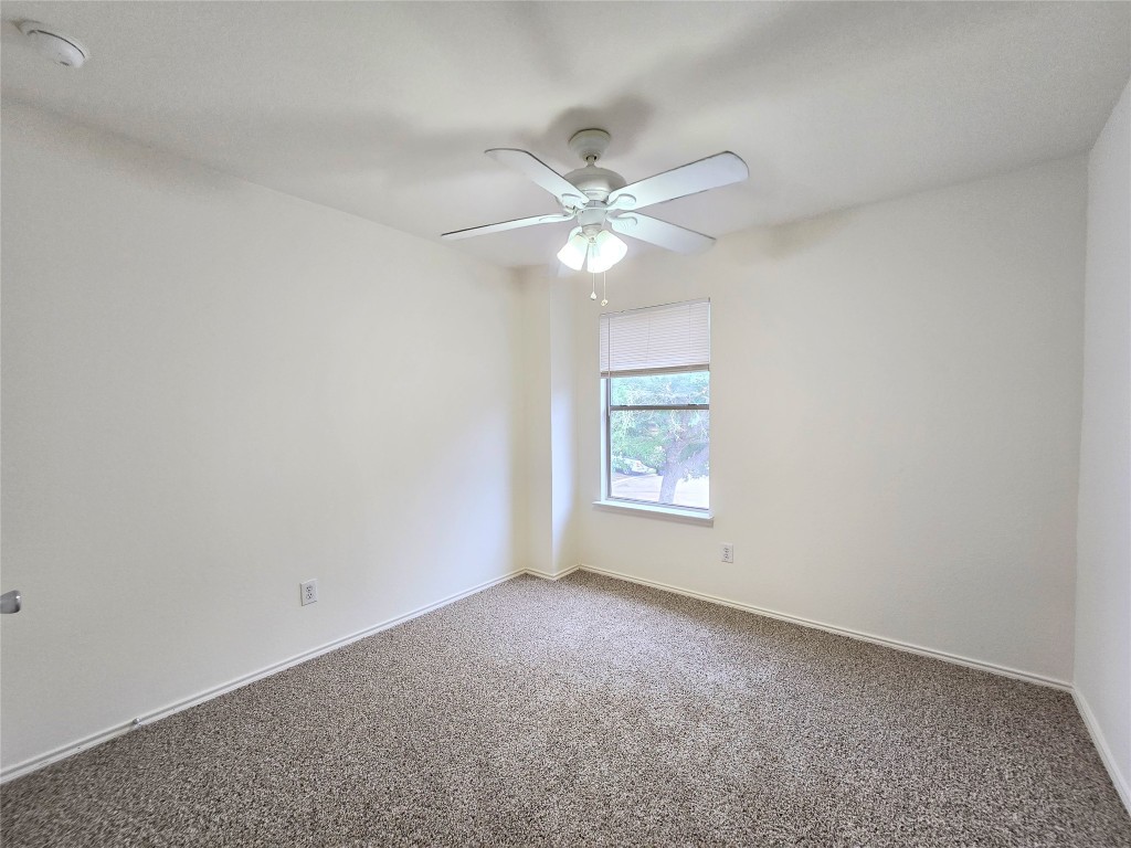 22911 Twisting Maple Court Spring, TX 77373 - Photo 30 of 37 an empty room with a window and a fan