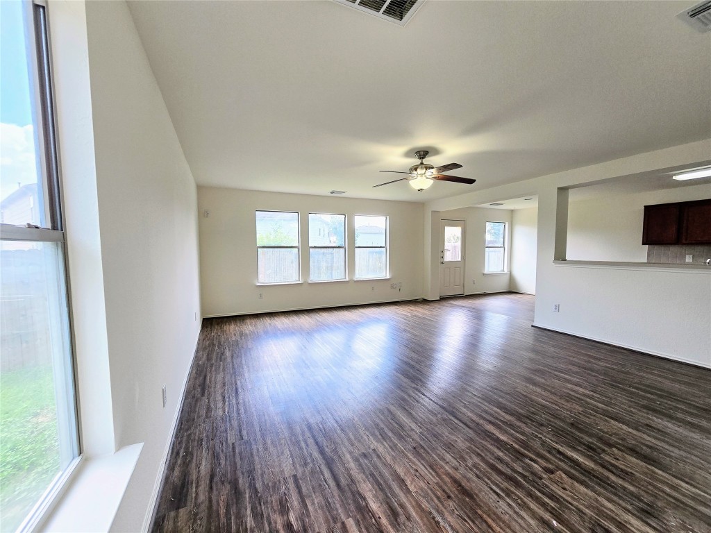 22911 Twisting Maple Court Spring, TX 77373 - Photo 9 of 37 a view of an empty room with wooden floor and a window