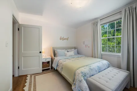 a bedroom with a bed and a window