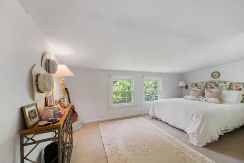 a bedroom with a bed a desk and chair