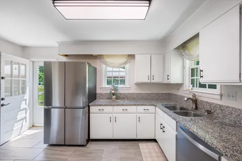 a kitchen with appliances a sink and a counter top space