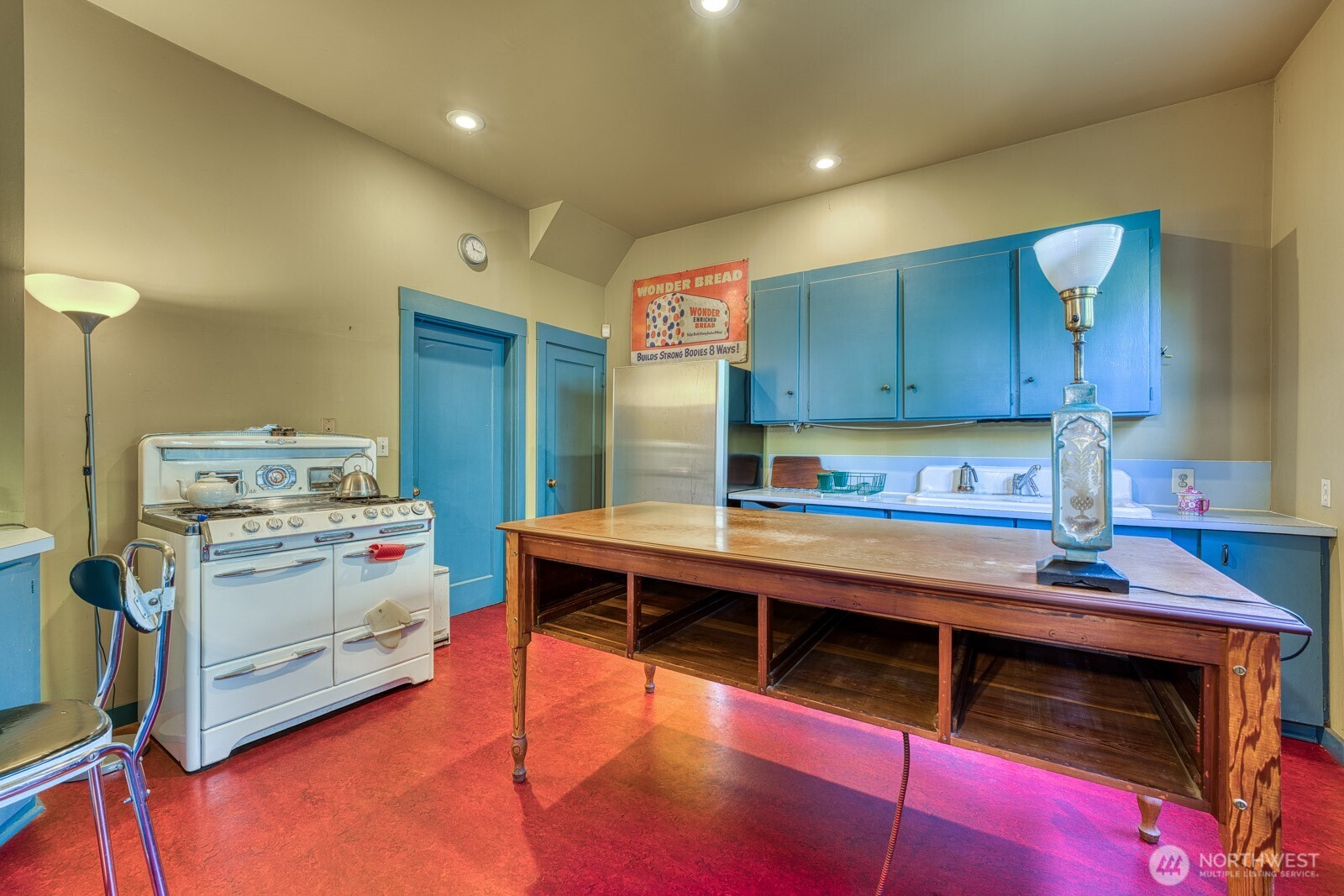 618 South 15th Street Tacoma, WA 98405 - Photo 7 of 30 a kitchen with kitchen island a stove and a refrigerator