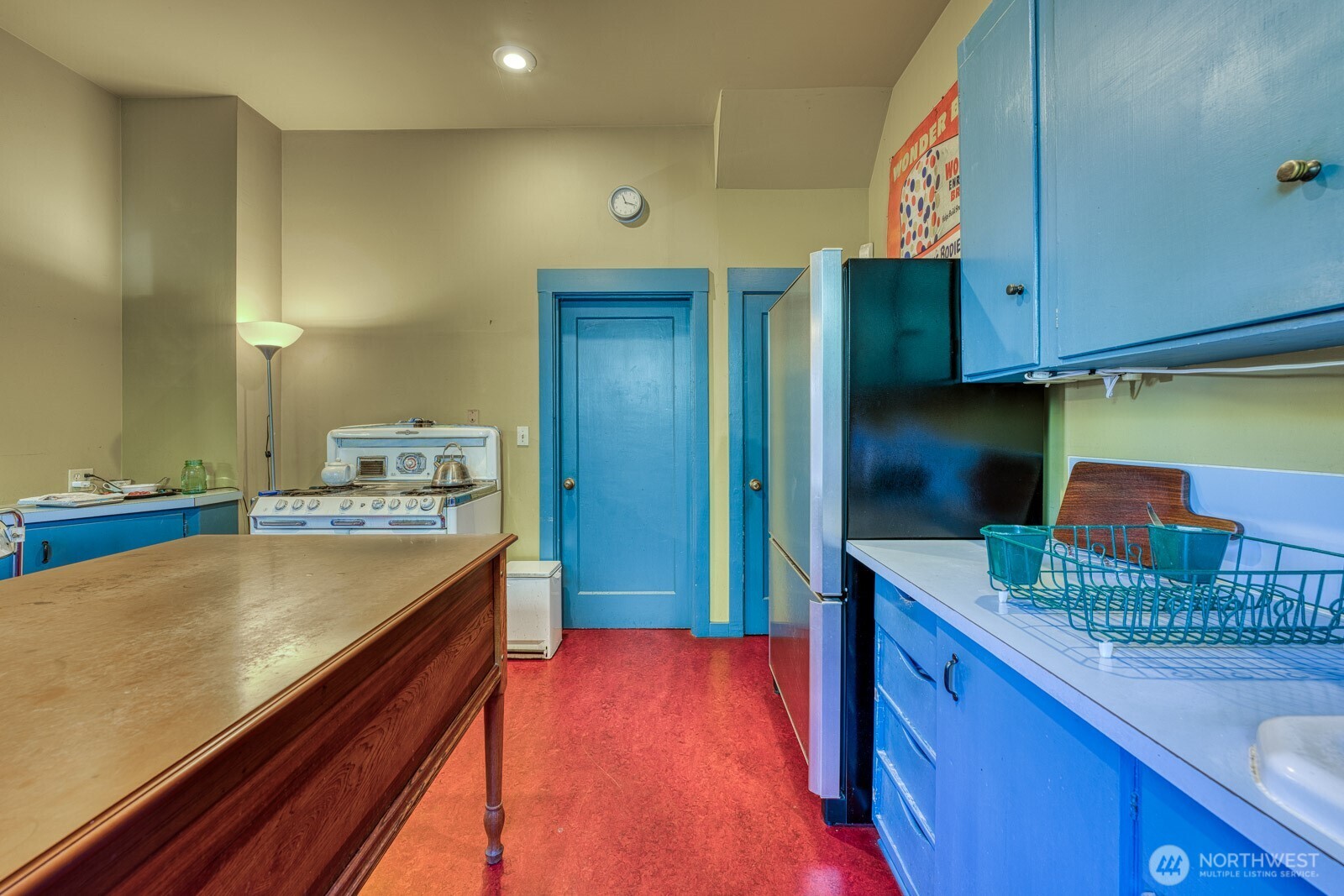 618 South 15th Street Tacoma, WA 98405 - Photo 10 of 30 a kitchen with stainless steel appliances granite countertop a sink and a refrigerator