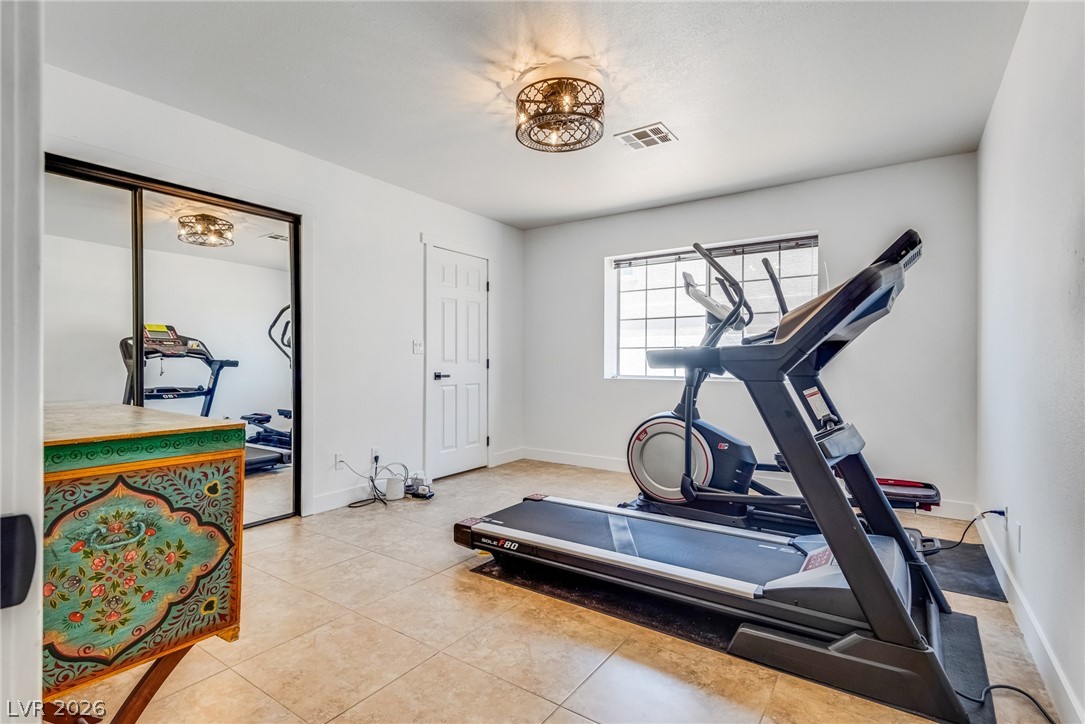 524 Swallow Cove Boulder City, NV 89005 - Photo 26 of 58 Fitness room with tiled floors and a reflective closet, perfect for invigorating workouts.