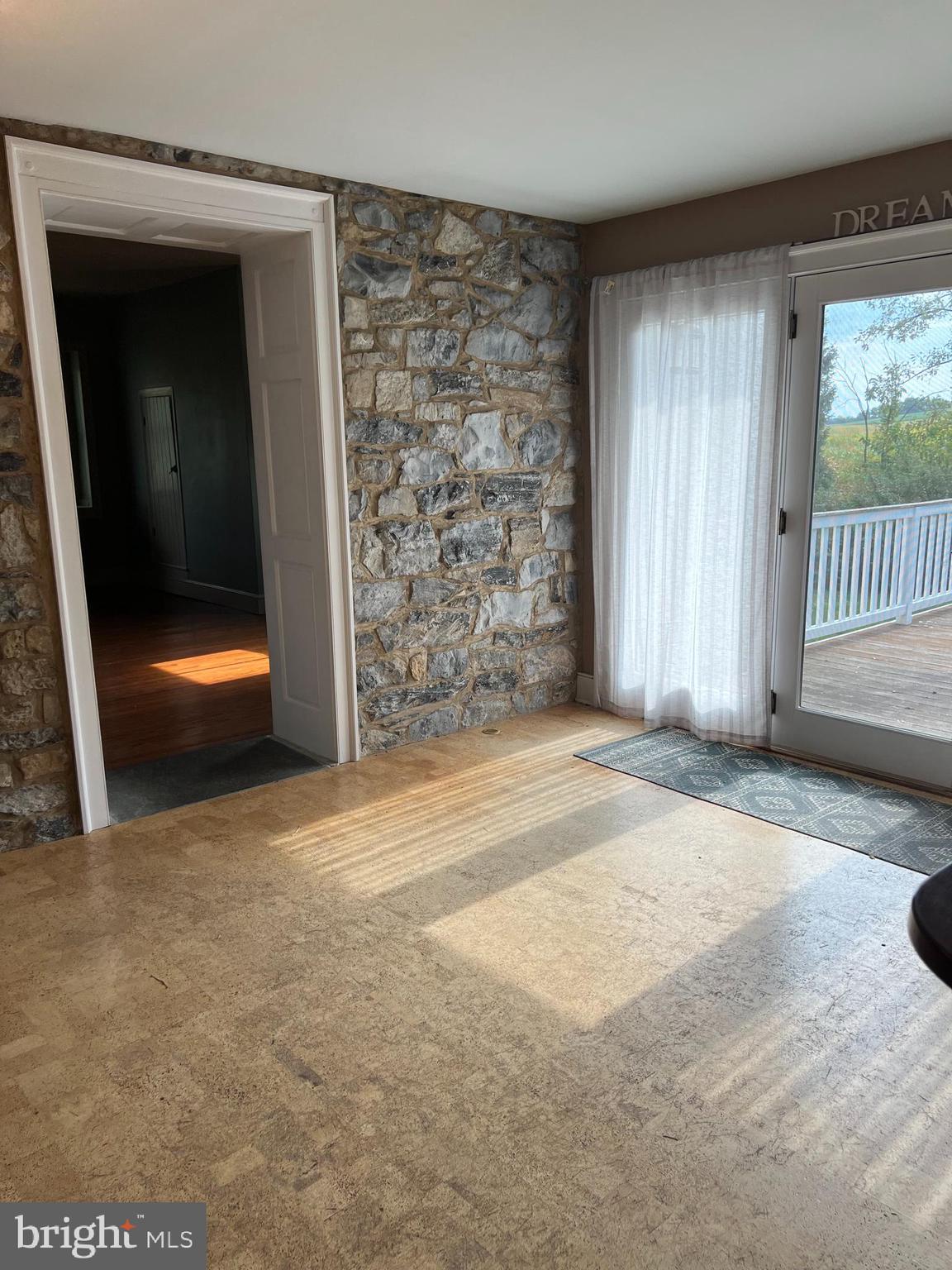 385 Albright Road Kutztown, PA 19530 - Photo 24 of 36 an empty room with sliding door and wooden floor