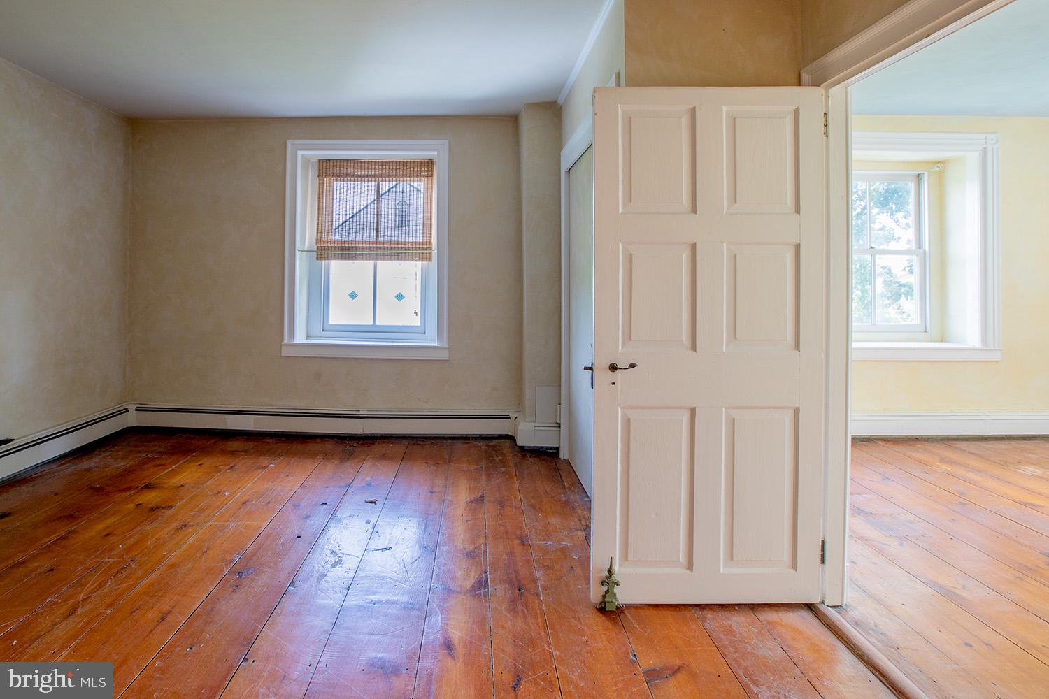 385 Albright Road Kutztown, PA 19530 - Photo 31 of 36 an empty room with wooden floor and windows