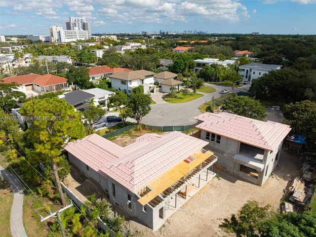 an aerial view of a residential houses with city view