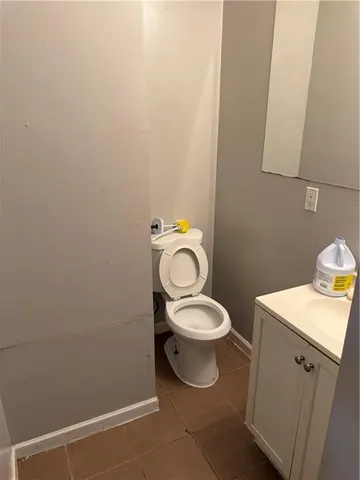 a white toilet sitting next to a bathroom sink