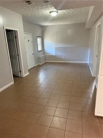 an empty room with windows and entrance