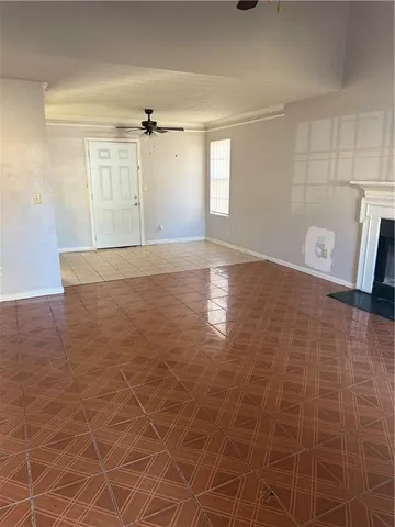 a view of a livingroom with an empty space and a window