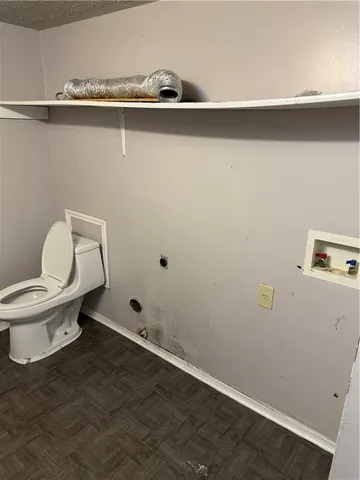 a white toilet sitting next to a sink