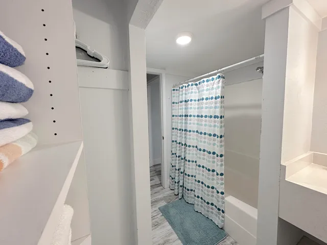 a bathroom with a bathtub and shower