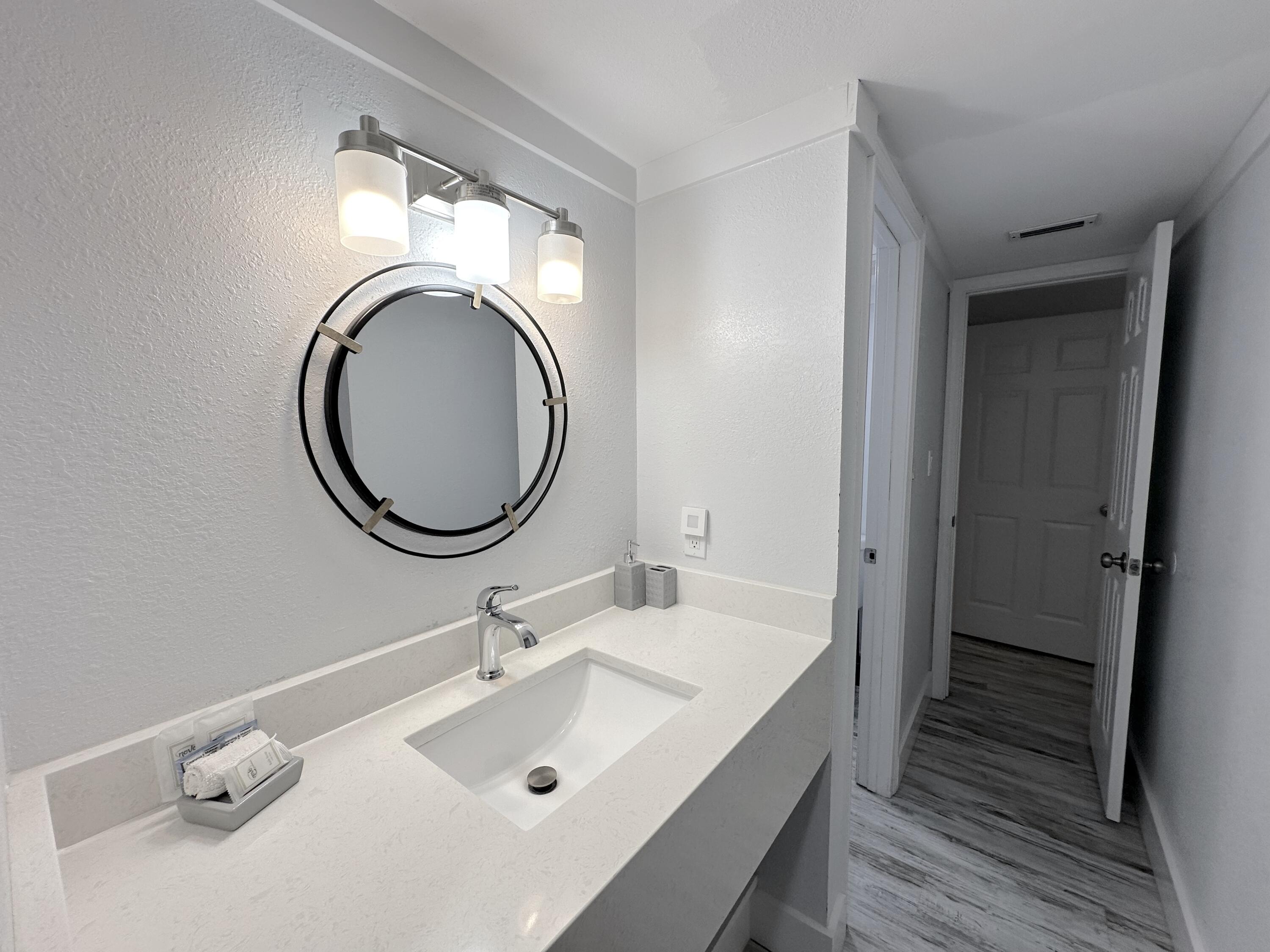 4000 Gulf Terrace Drive, Unit 1000 Destin, FL 32541 - Photo 14 of 37 a bathroom with a sink and a mirror
