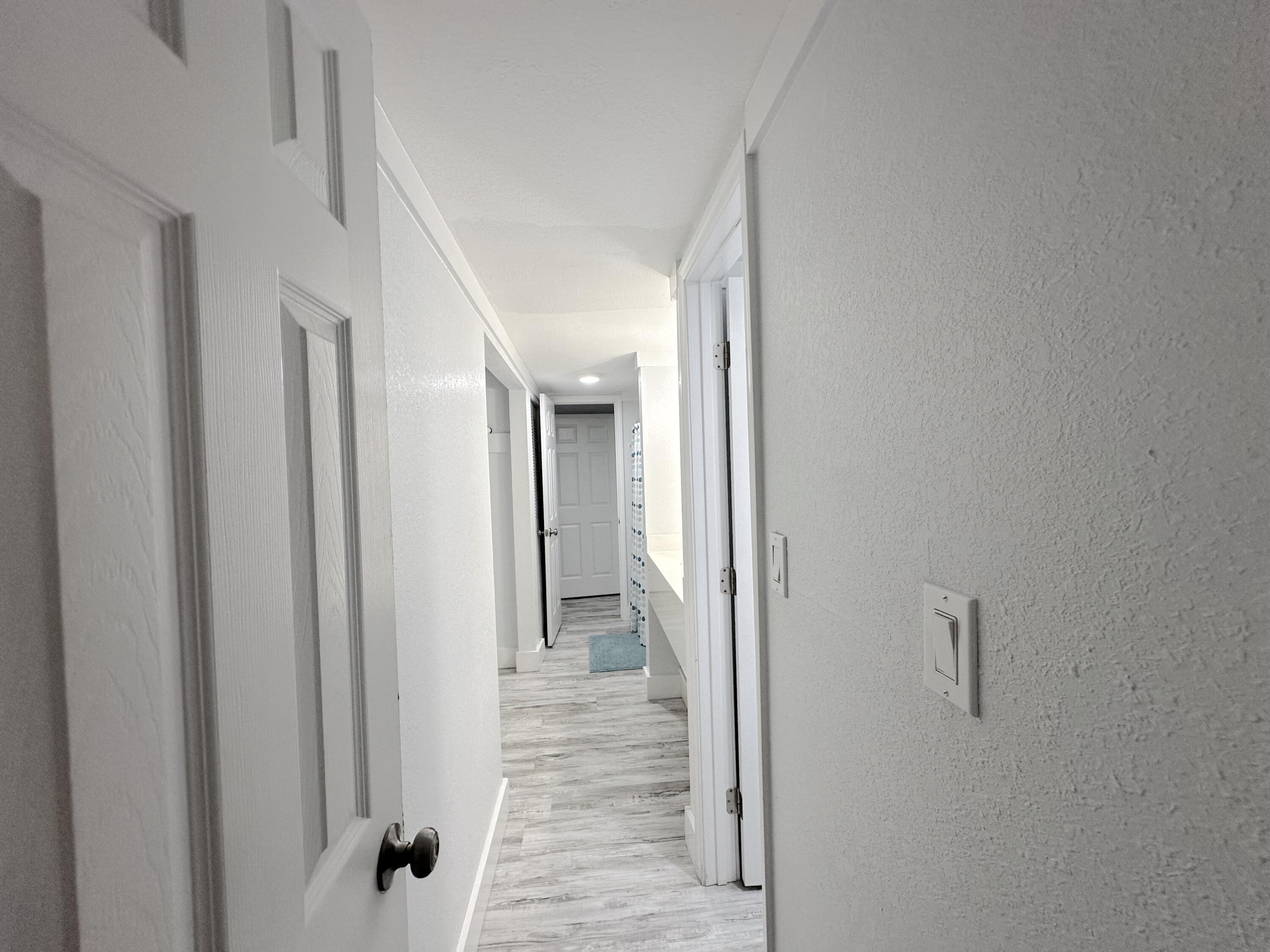4000 Gulf Terrace Drive, Unit 1000 Destin, FL 32541 - Photo 20 of 37 a view of a hallway with wooden floor and staircase
