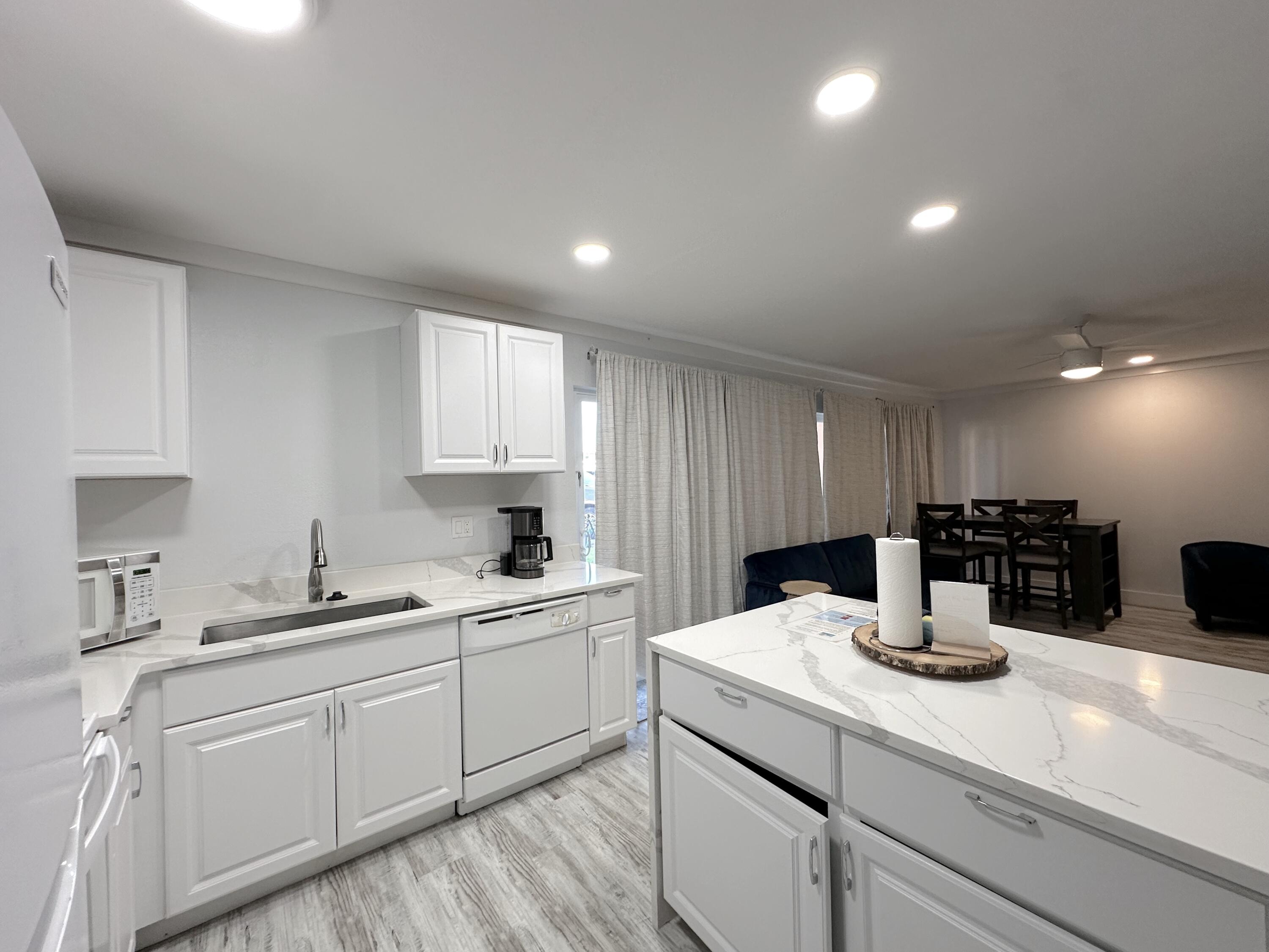 4000 Gulf Terrace Drive, Unit 1000 Destin, FL 32541 - Photo 2 of 37 a kitchen with a sink and cabinets