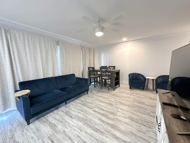 a living room with furniture and wooden floor