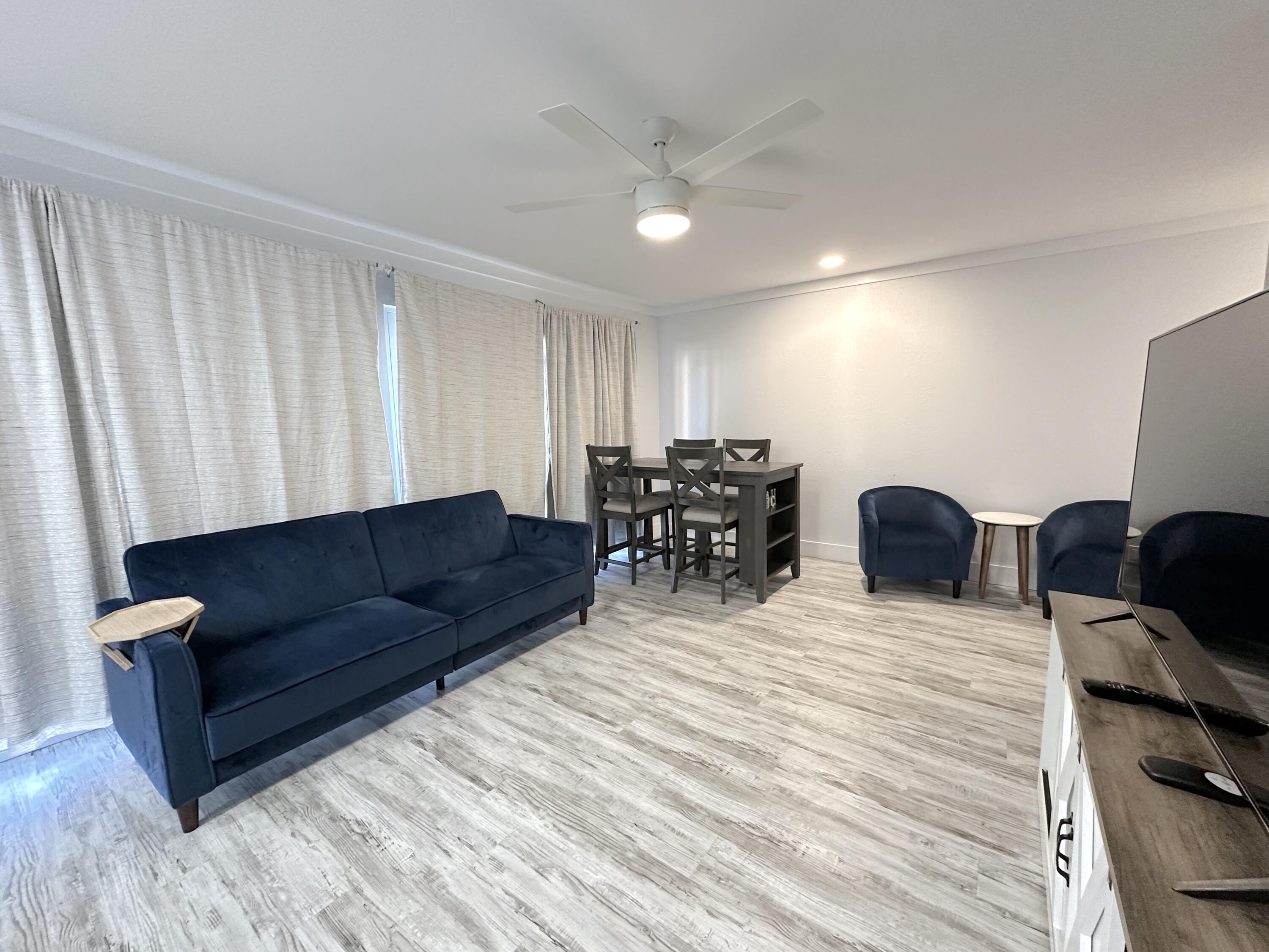 4000 Gulf Terrace Drive, Unit 1000 Destin, FL 32541 - Photo 5 of 37 a living room with furniture and wooden floor