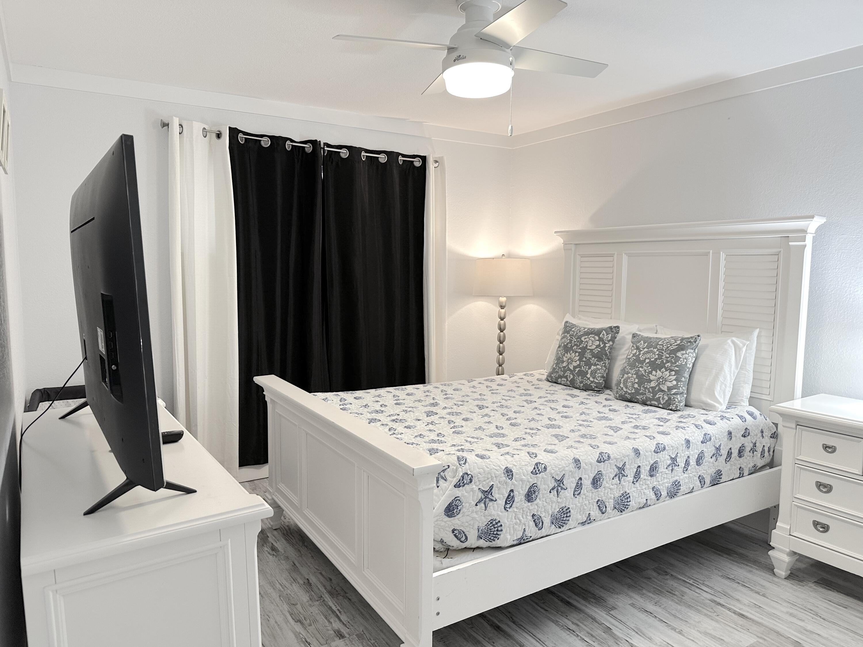 4000 Gulf Terrace Drive, Unit 1000 Destin, FL 32541 - Photo 8 of 37 a bedroom with a bed and a flat tv screen on dresser