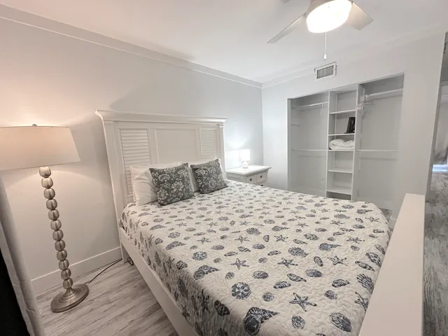 a bedroom with a bed and wooden floor