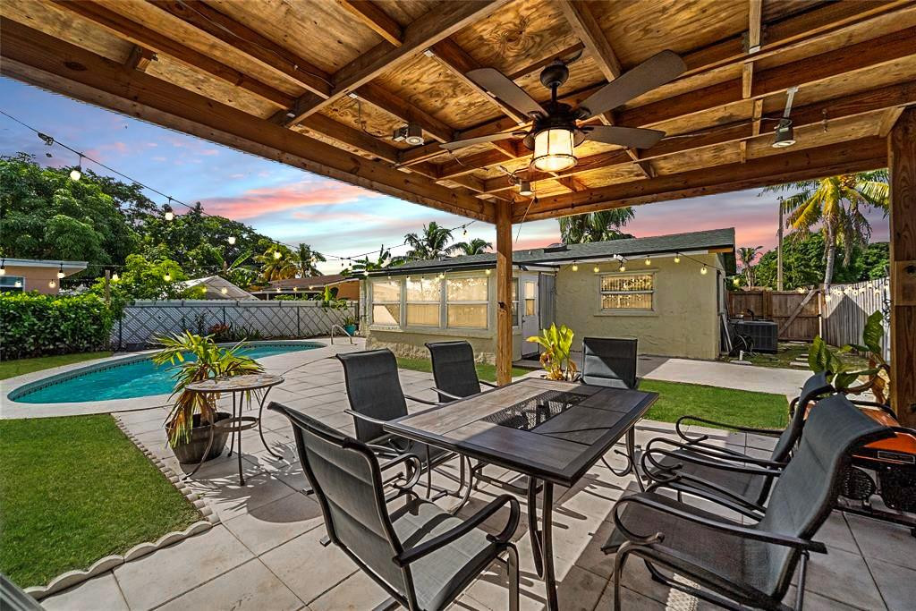 a view of a patio with table and chairs and potted plants