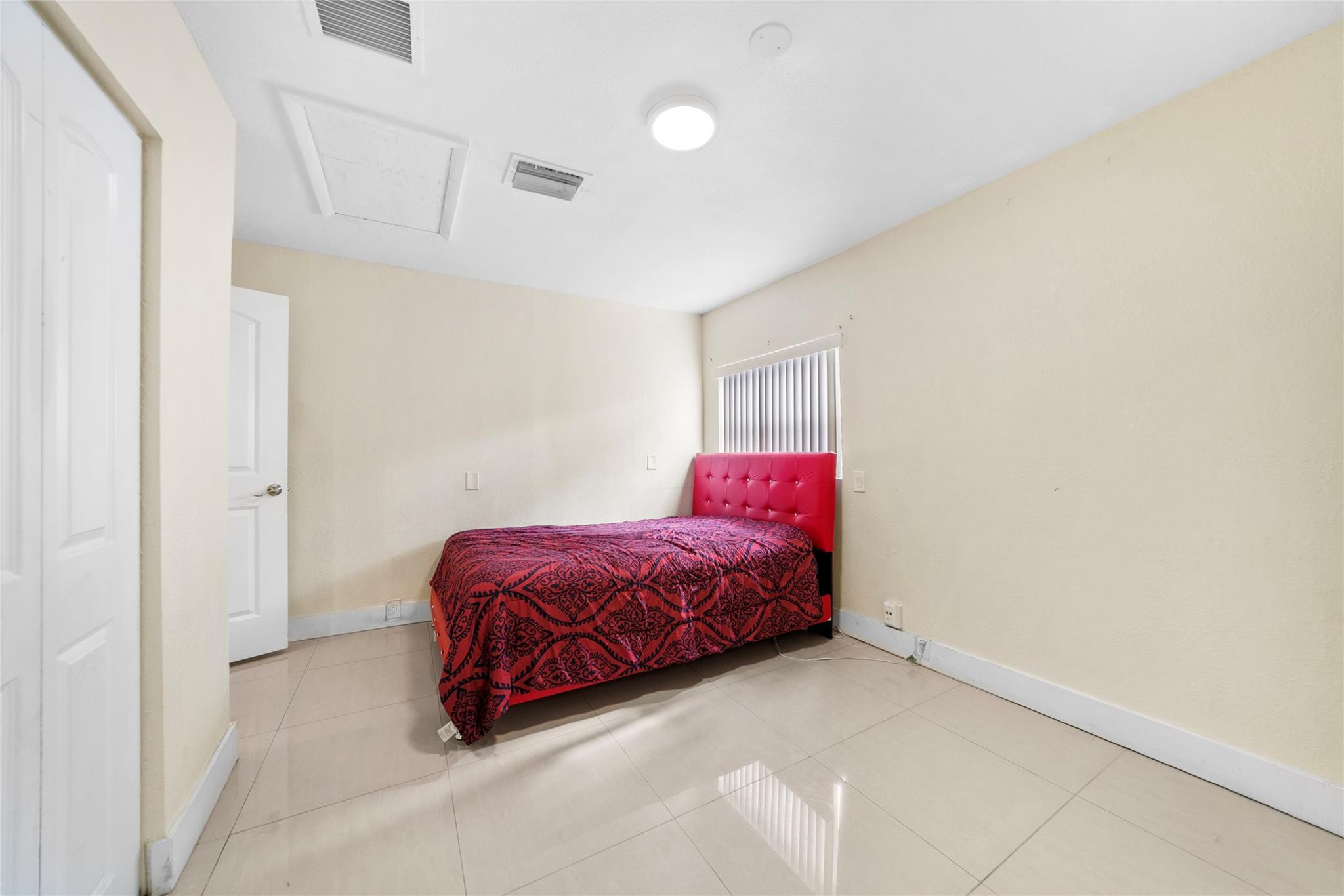520 Southwest 72nd Terrace North Lauderdale, FL 33068 - Photo 18 of 35 a spacious bedroom with a bed and a cabinets