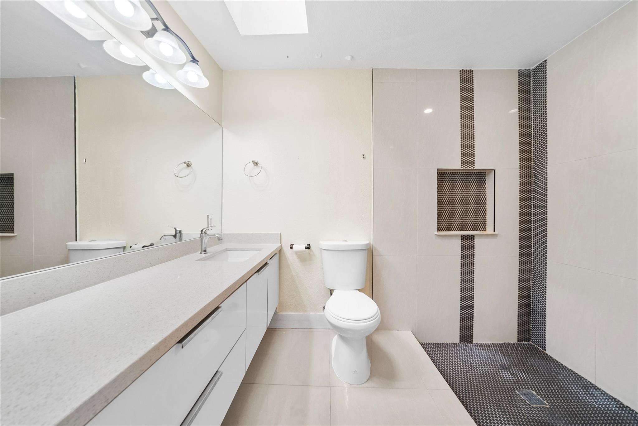 520 Southwest 72nd Terrace North Lauderdale, FL 33068 - Photo 19 of 35 a spacious bathroom with a toilet sink and mirror