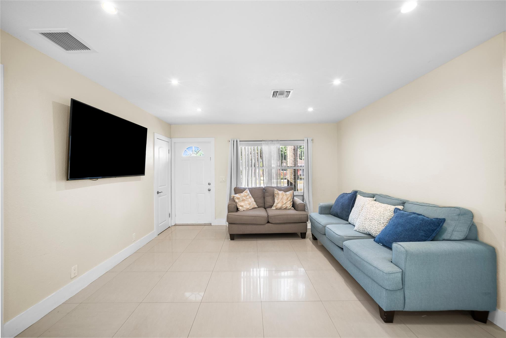 520 Southwest 72nd Terrace North Lauderdale, FL 33068 - Photo 5 of 35 a living room with furniture and a flat screen tv