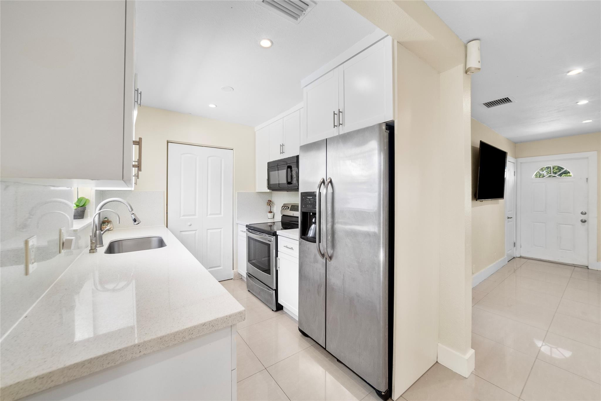 520 Southwest 72nd Terrace North Lauderdale, FL 33068 - Photo 8 of 35 a kitchen with stainless steel appliances granite countertop a refrigerator and a sink