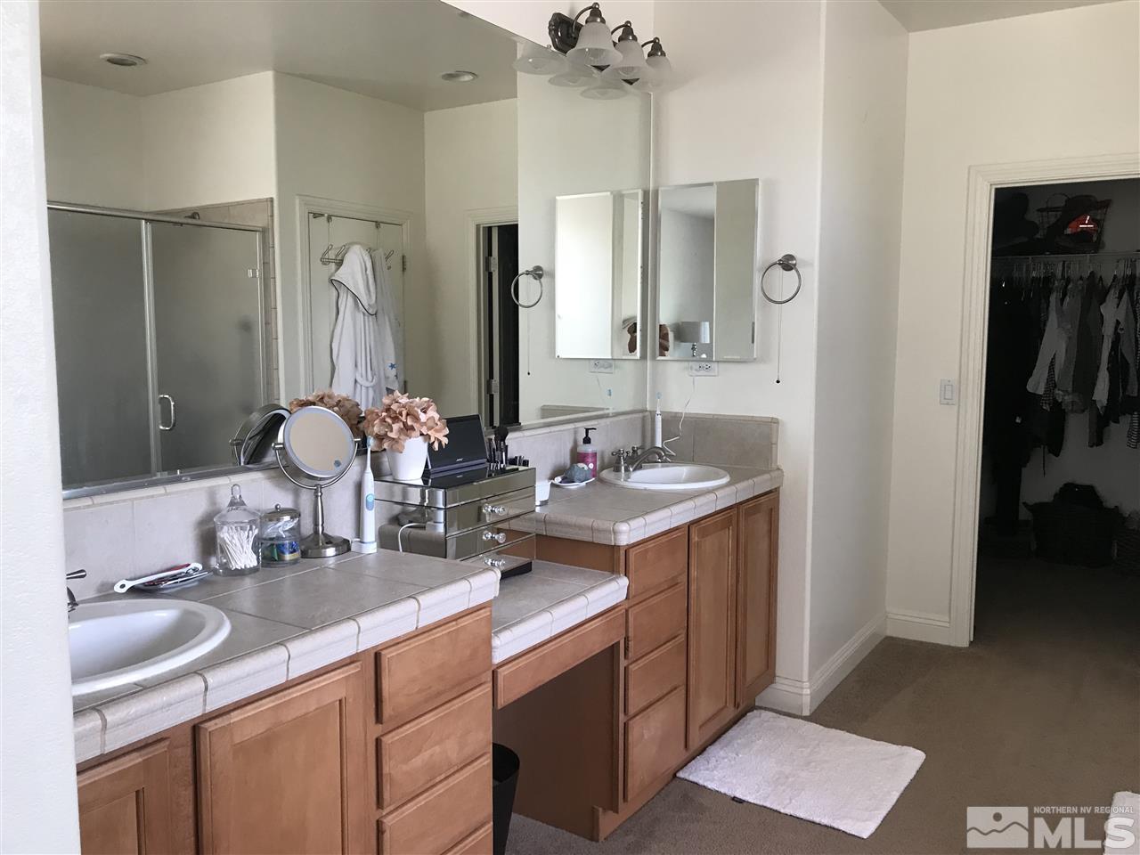 615 Equine Court Reno, NV 89521 - Photo 13 of 25 a bathroom with a double vanity sink and a mirror
