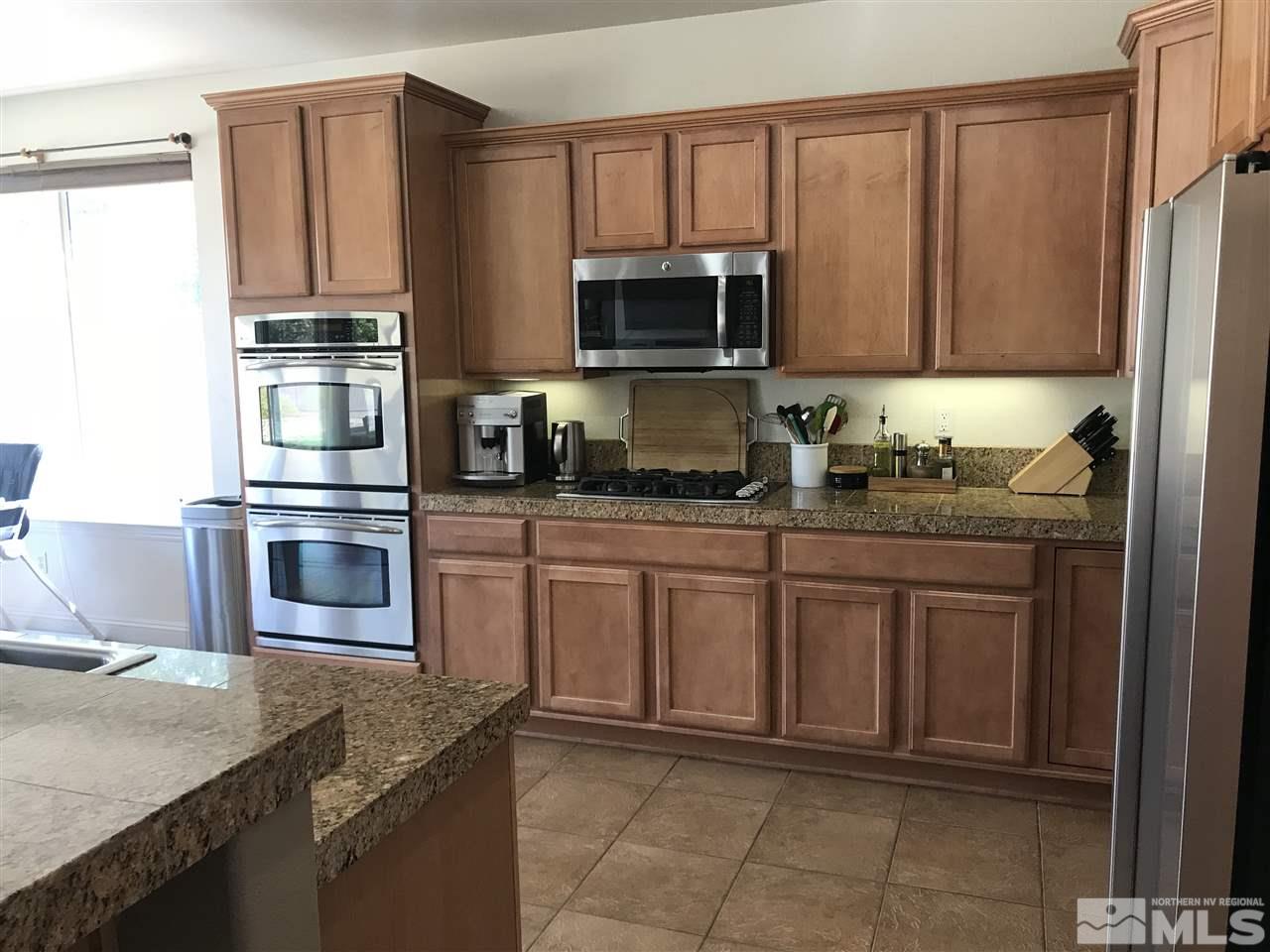 615 Equine Court Reno, NV 89521 - Photo 3 of 25 a kitchen with stainless steel appliances granite countertop a refrigerator stove and microwave