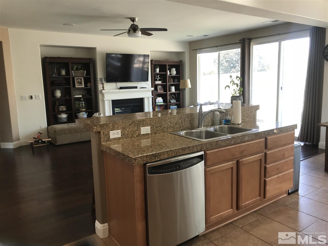 615 Equine Court Reno, NV 89521 - Photo 5 of 25 a kitchen with stainless steel appliances granite countertop a sink and a microwave