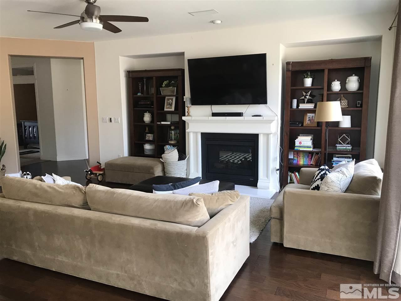 615 Equine Court Reno, NV 89521 - Photo 8 of 25 a living room with furniture a fireplace and a flat screen tv