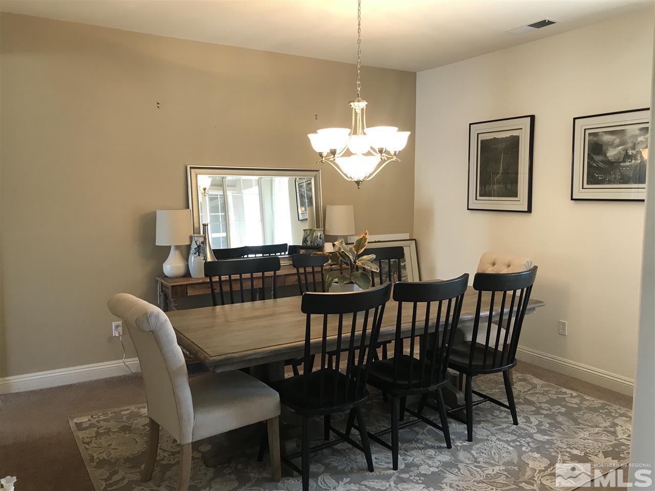 615 Equine Court Reno, NV 89521 - Photo 10 of 25 a view of a dining room with furniture and chandelier