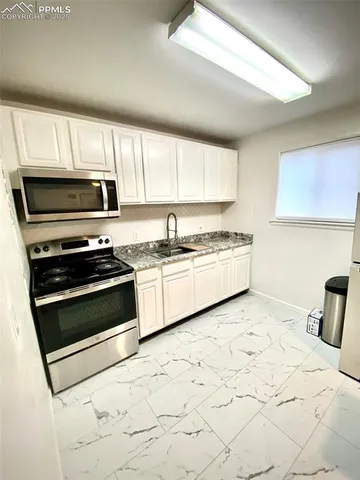 a kitchen with a stove and a microwave