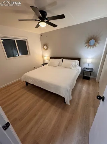 a bedroom with a bed and a ceiling fan