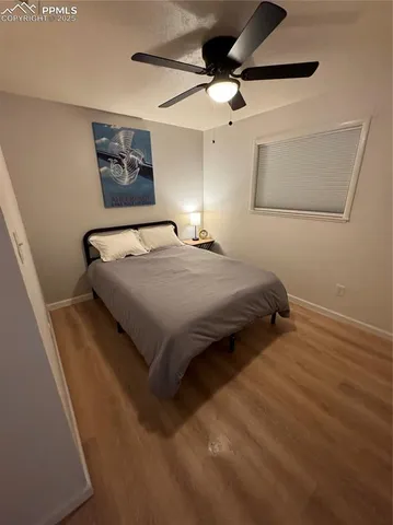 a bedroom with a bed and a painting on the wall