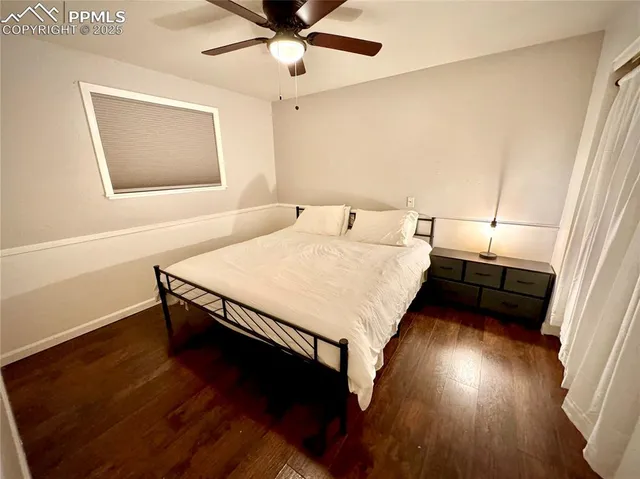 a bedroom with a bed and a ceiling fan