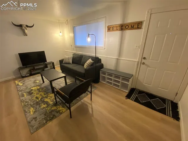 a living room with furniture and a flat screen tv