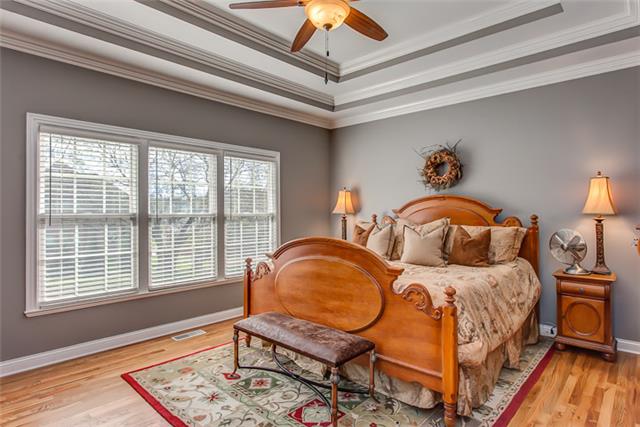 232 Chester Stevens Road Franklin, TN 37067 - Photo 11 of 20 DOUBLE TREY CEILINGED W/A FULL WALL OF WINDOWS TO LET THE OUTSIDE IN, THE OWNER'S SUITE IS COMPLETE W/UPGRADED CEILING FAN, HARDWOOD FLOORING, FULL EN-SUITE W/LARGE DOUBLE SIDED CLOSET, SEPARATE TUB, LARGE SHOWER, DUAL SINKS & PRIVATE H2O CLOSET!