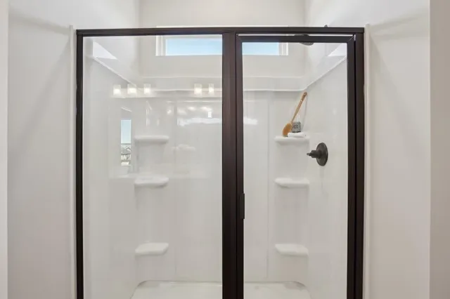 a bathroom with a glass shower door