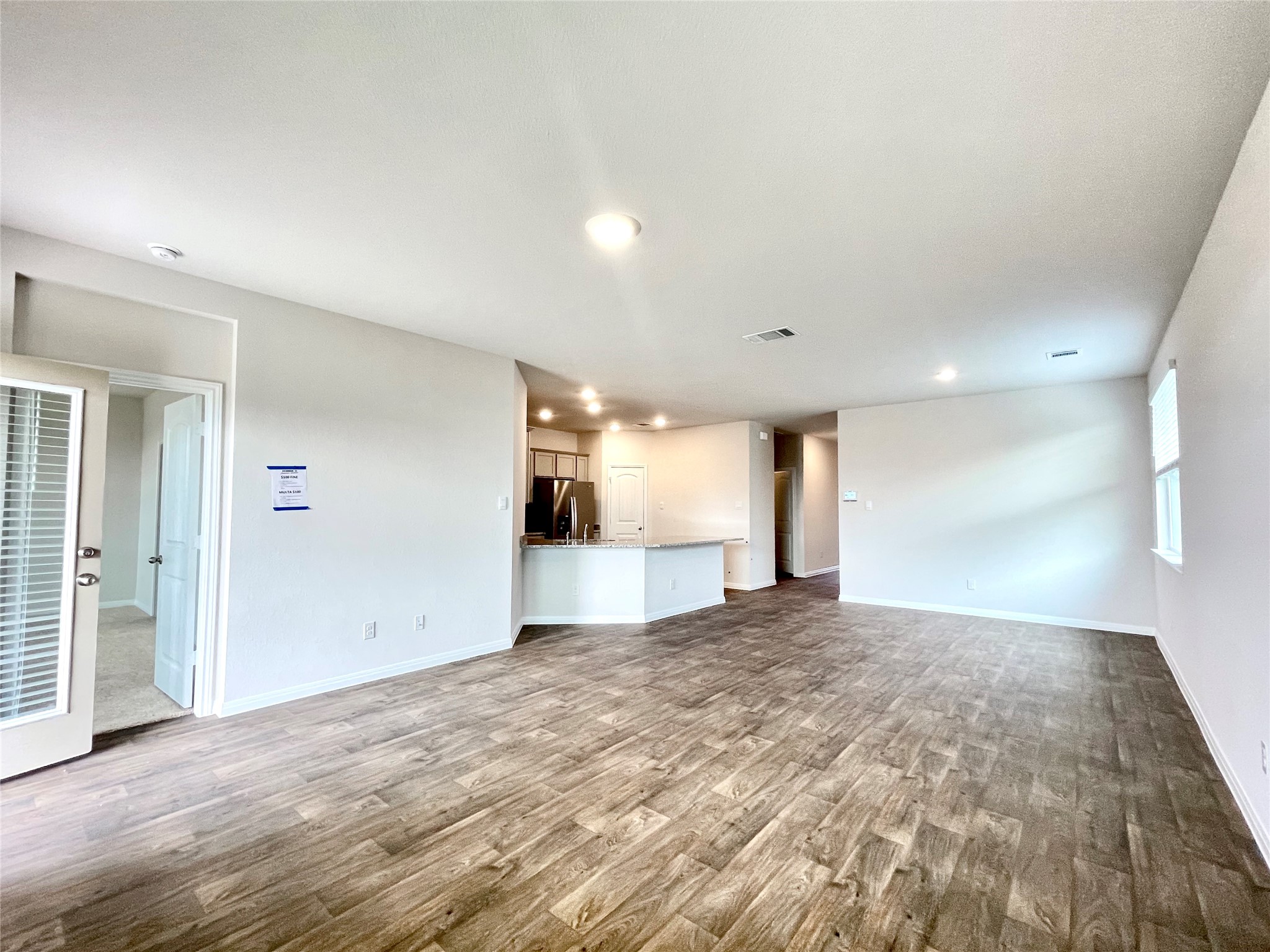 467 Evergreen Sumac Loop Kyle, TX 78640 - Photo 16 of 40 a view of a big room with wooden floor and windows