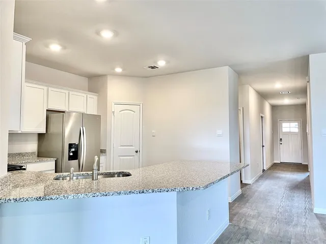 a bathroom with a granite countertop sink and a large mirror