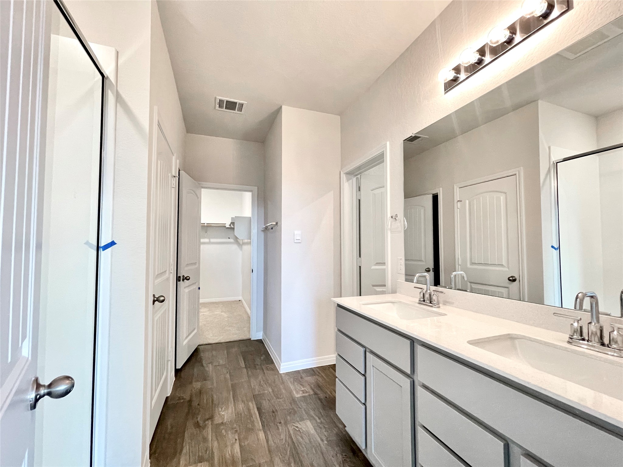 467 Evergreen Sumac Loop Kyle, TX 78640 - Photo 27 of 40 a bathroom with a double vanity sink and mirror with shower