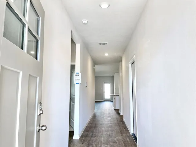 a view of a hallway with a white walls