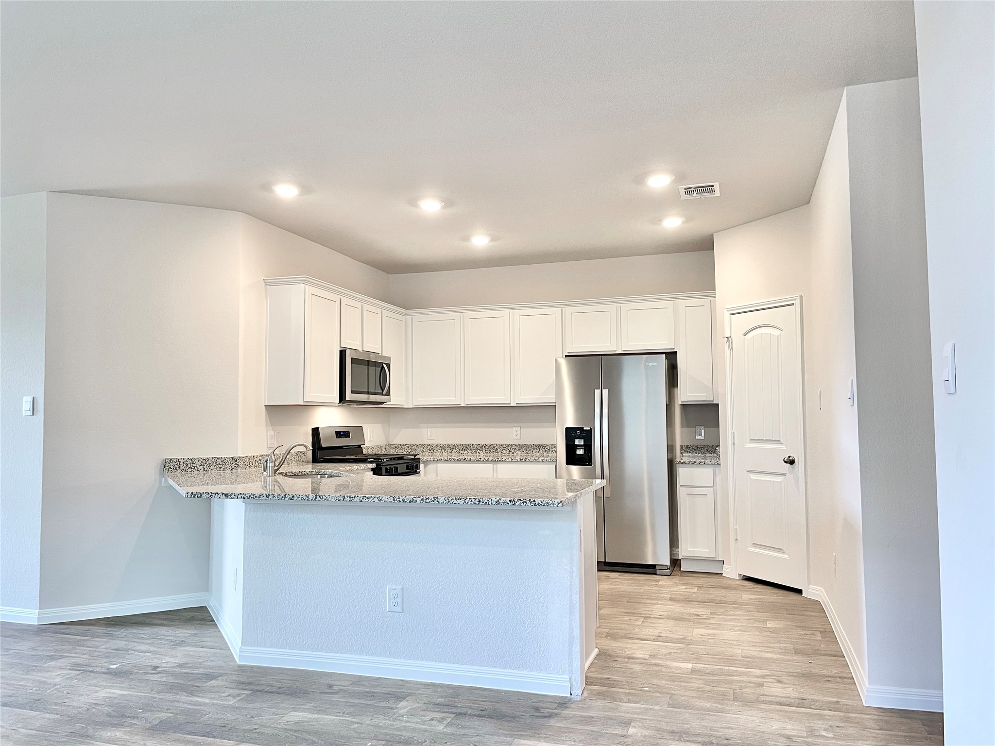 467 Evergreen Sumac Loop Kyle, TX 78640 - Photo 8 of 40 a kitchen with stainless steel appliances granite countertop a refrigerator and a stove